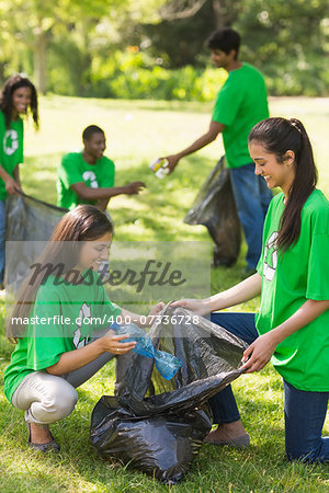 Team of young volunteers picking up litter in the park