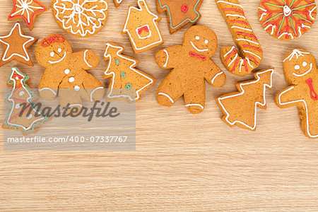 Homemade various christmas gingerbread cookies on wooden background with copy space