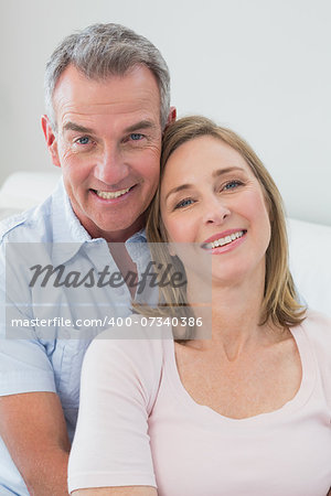 Portrait of a happy couple embracing in the living room at home