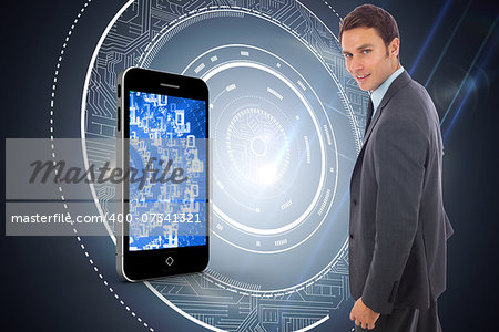 Cheerful handsome businessman standing  against black background with glowing circle
