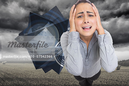 Desperate businesswoman against misty landscape with bales of straw