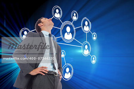 Cheerful businessman with hands on hips against digital earth background