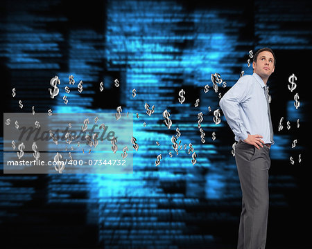 Serious businessman with hand on hip against blue blurred texts