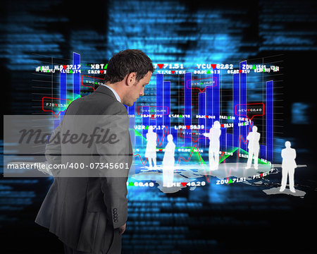 Serious businessman with hands on hips against blue blurred texts