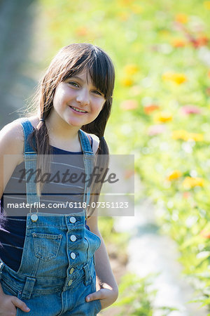 Summer on an organic farm. A young girl in a field of flowers.