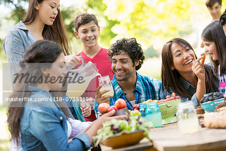 Adults and children around a table in a garden.