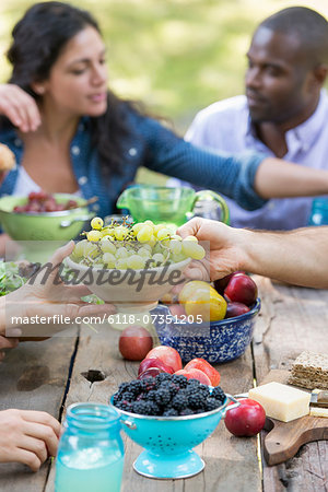 Adults and children around a table at a party in a garden.