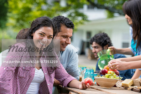 A summer party outdoors. Friends around a table.