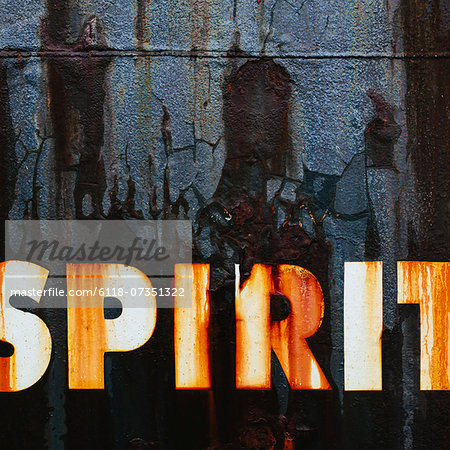 Close up of an old, rusty, commercial fishing boat. The word Spirit painted on the hull.