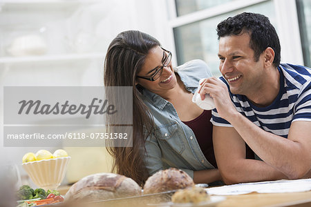 An office or apartment interior in New York City. Two people, a couple beside the breakfast bar.
