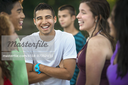 A group of young people, teenagers, friends laughing and joking.