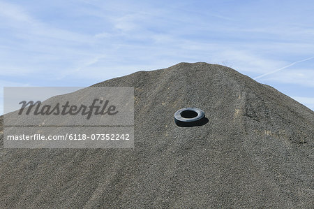 Gravel piles are used for road maintenance and construction purposes.