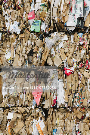 Recycling facility with bundles of cardboard sorted and tied up for recycling.