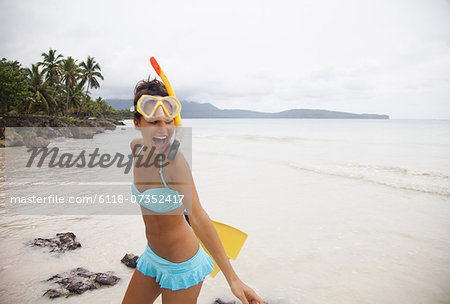 A young woman wearing a bikini on a secluded beach on the Samana Peninsula in the Dominican Republic.