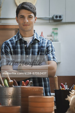 Organic Farm. A young man in a potting shed by work bench.