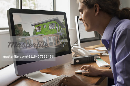 Architects discussing a green construction project, designing and building efficient environmentally friendly buildings. Green architectural practice. Architects discussing a green construction project, designing and building efficient environmentally friendly buildings. Green architectural practice.