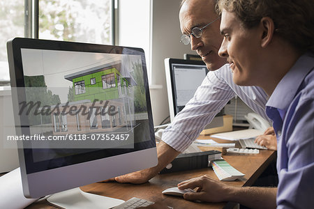 Architects discussing a green construction project, designing and building efficient environmentally friendly buildings. Green architectural practice.