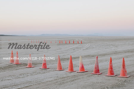 Row of traffic cones on the flat desert surface of  Black Rock, Nevada.