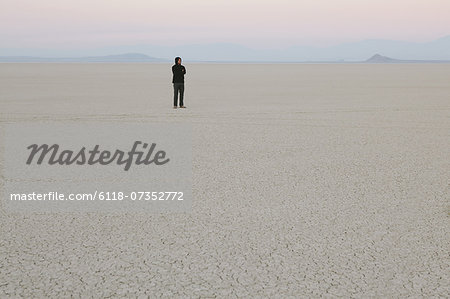 Man standing in vast, desert landscape