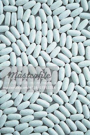 Vitamin C supplements, small blue oval tablets.