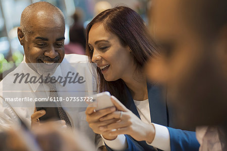 City life. A group of people sitting in a coffee shop, using mobile phones, and talking to each other. City life. A group of people sitting in a coffee shop, using mobile phones, and talking to each other.