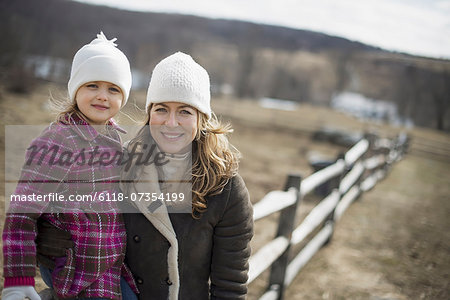 A woman and child walking along a path hand in hand.