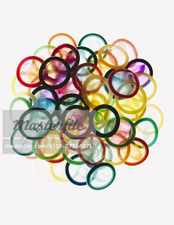 A pile of multi-colored condoms on a white background.