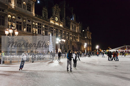 Ice skaters at the town hall Hotel de Ville at Christmas season, Paris, Ile de France, France, Europe