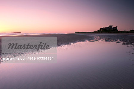 Bamburgh Castle and the beach at dawn in Bamburgh, Northumberland, England, United Kingdom, Europe Bamburgh Castle and the beach at dawn in Bamburgh, Northumberland, England, United Kingdom, Europe