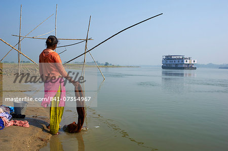 Woman with laundry and sukapha boat on the Hooghly River, part of Ganges River, West Bengal, India, Asia