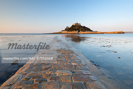 The stone causeway leading to St. Michaels Mount in early morning sunshine, Marazion, Cornwall, England, United Kingdom, Europe