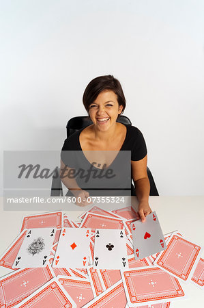 Mid-Adult Woman doing Magic Trick with Deck of Cards