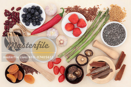 Super food selection forming an abstract background of handmade mottled paper..