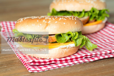 Bagel with fresh cheese and fresh lettuce on napkin