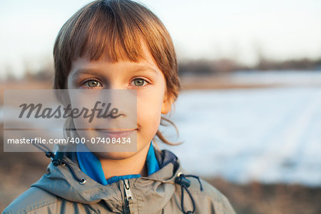 Handsome smiling boy on a background of nature on