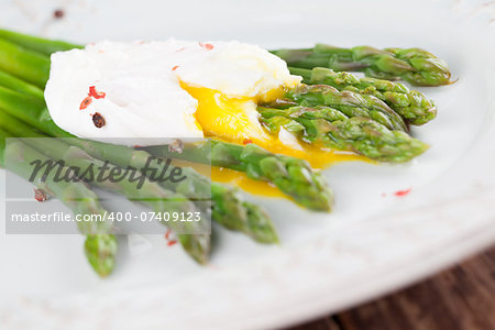 Green asparagus with poached egg on a plate