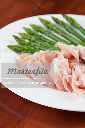 Prosciutto and green asparagus on a plate