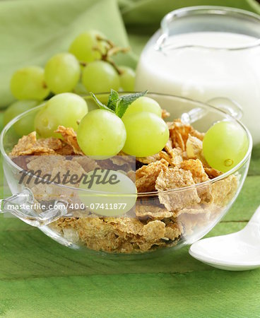 healthy breakfast of muesli with milk and green grapes