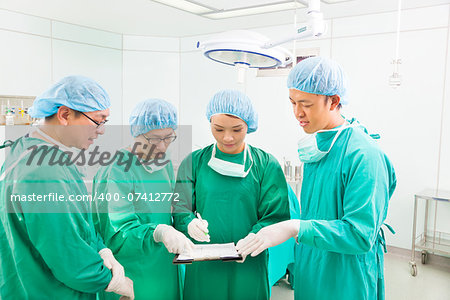 surgeons discussing about something in operating theater