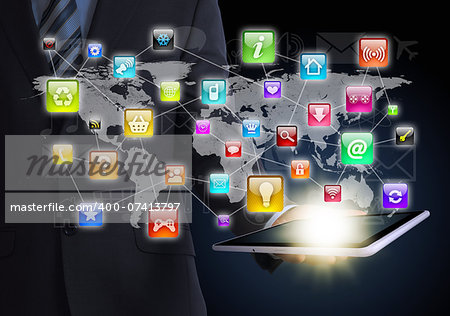 Man in suit holding tablet in hand. Application icons around tablet. The concept of software
