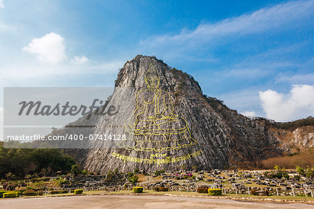 Carved buddha image from gold on the cliff at Khao Chee Jan, Pattaya, Thailand