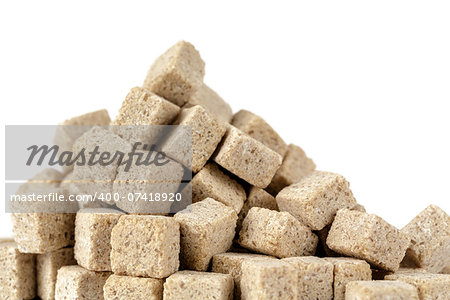 Brown sugar cubes stacked against white background