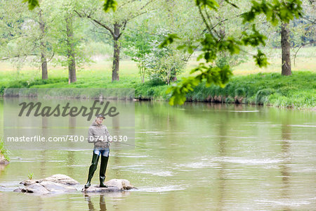 woman fishing in Sazava river, Czech Republic