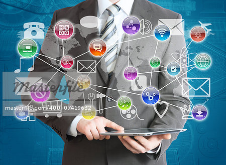 Man in suit holding tablet pc and application icons in hand. The concept of software