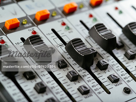 Macro photo of faders of a studio soundboard.