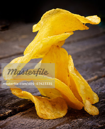 Arrangement of Crispy Cheese Potato Chips closeup on Rustic Wooden background