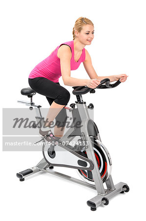 young woman doing indoor biking exercise on spinner
