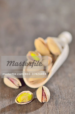 Pistachio nuts on wooden scoops