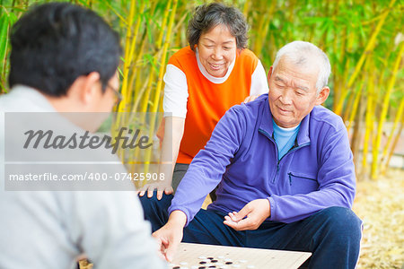 seniors play traditional chinese board game Go