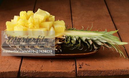dessert pineapple sliced on a wooden plate